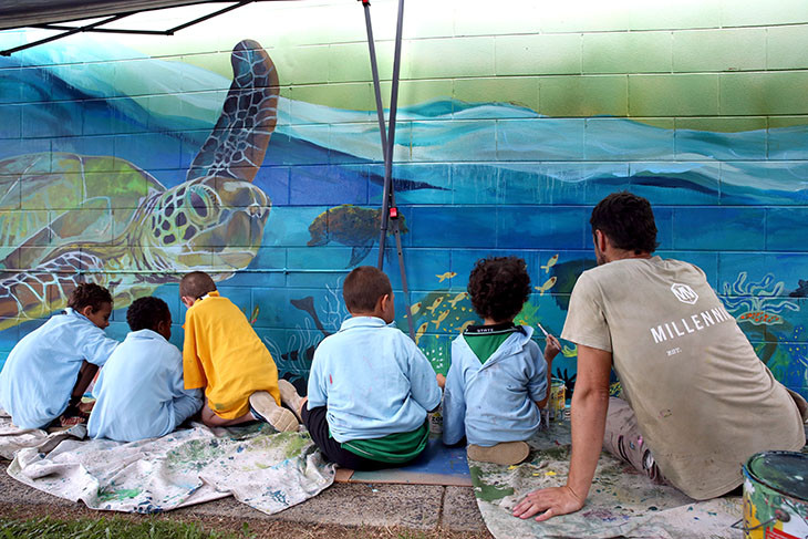 Students from Silkwood State School painting art mural with local artist Cam Scale, supported by the Regional Arts Development Fund 2025. Picture: Supplied
