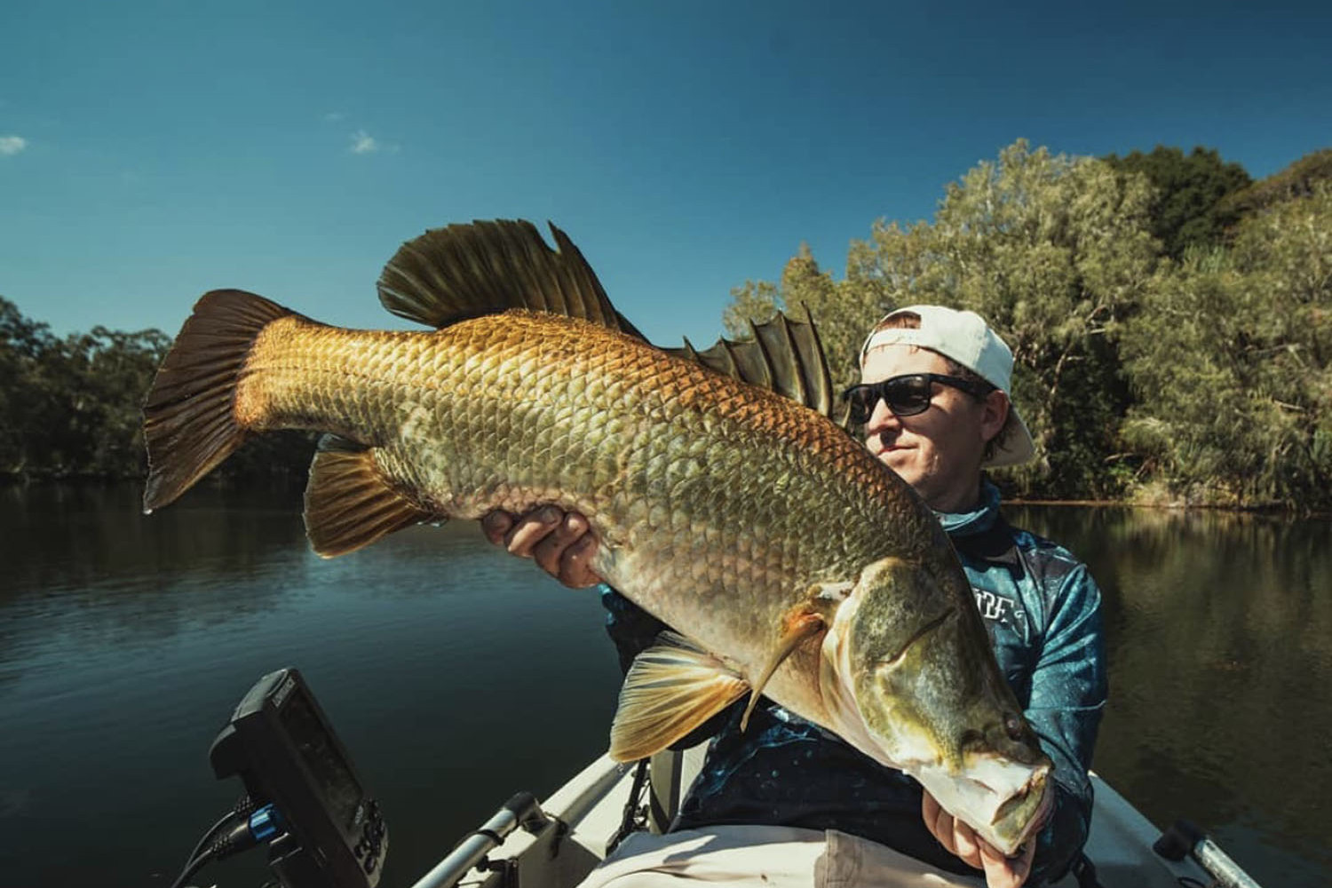 A happy angler with a beautiful barramundi. Picture: Instagram @adrian.tuck