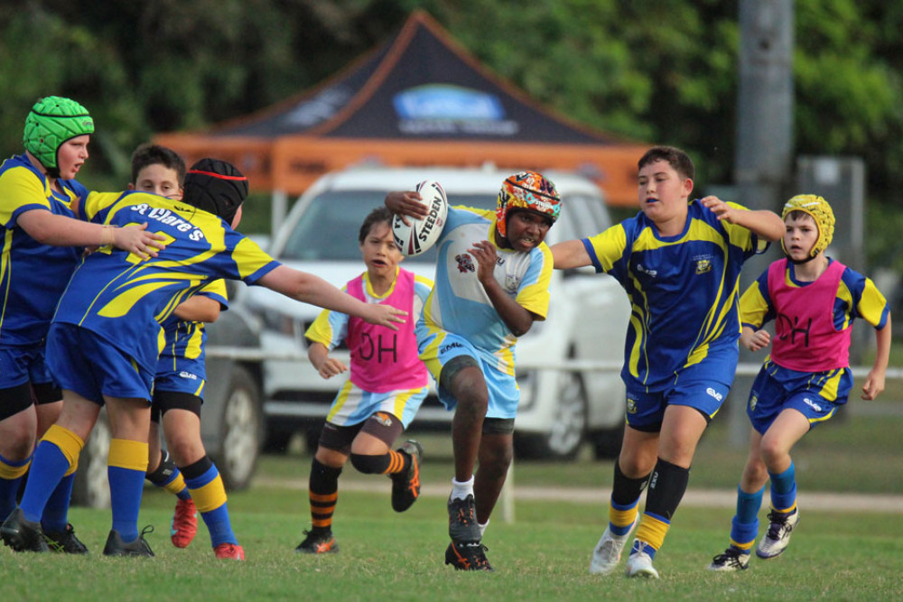 Jackyron from Tully State School (with ball) made solid metres. Picture: Maria Girgenti