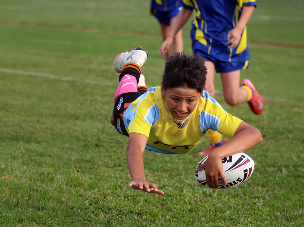 Matai (surname withheld) went in to score for Tully State School at the Ken Hamill Cup game against St Clare’s School at Tully Showgrounds. Picture: Maria Girgenti